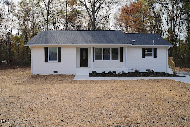 ranch-style home featuring crawl space, roof with shingles, and brick siding