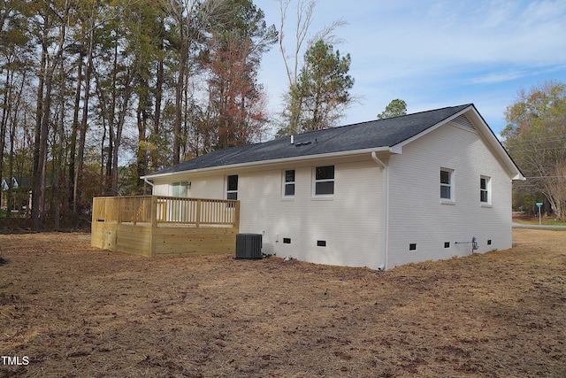 rear view of house featuring a wooden deck and central AC