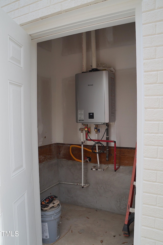 utility room featuring water heater