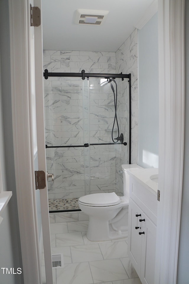 bathroom featuring toilet, marble finish floor, a stall shower, and visible vents