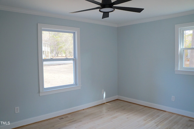 spare room with baseboards, visible vents, crown molding, and light wood finished floors