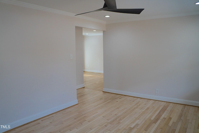 empty room featuring ornamental molding, light wood-type flooring, baseboards, and recessed lighting