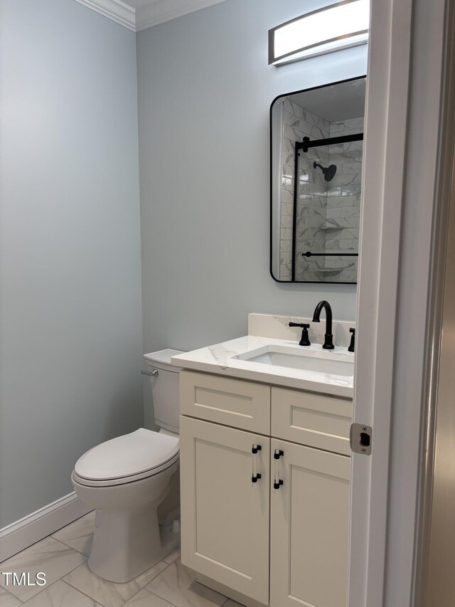 full bath featuring toilet, vanity, marble finish floor, ornamental molding, and a tile shower