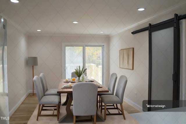 dining space featuring ornamental molding, a barn door, baseboards, and recessed lighting