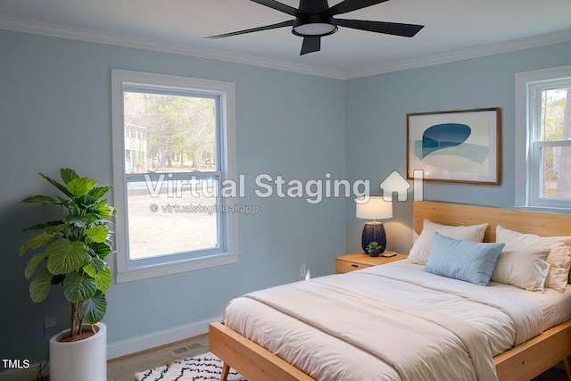 bedroom featuring visible vents, crown molding, and wood finished floors