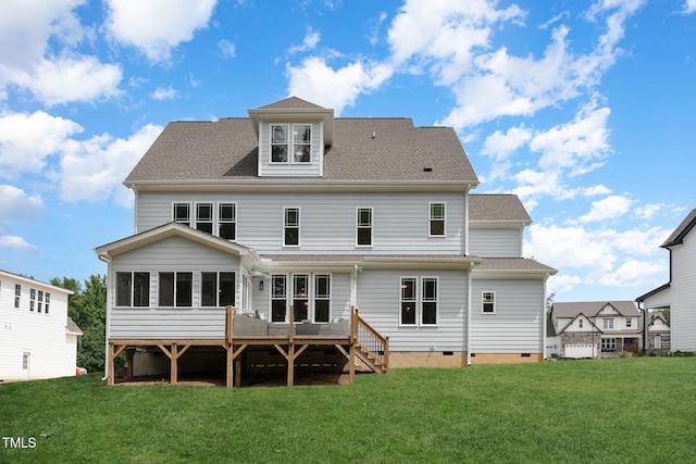 rear view of house featuring a lawn and a wooden deck