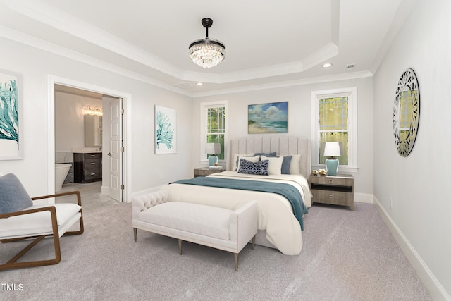 bedroom featuring light colored carpet, crown molding, connected bathroom, and a tray ceiling