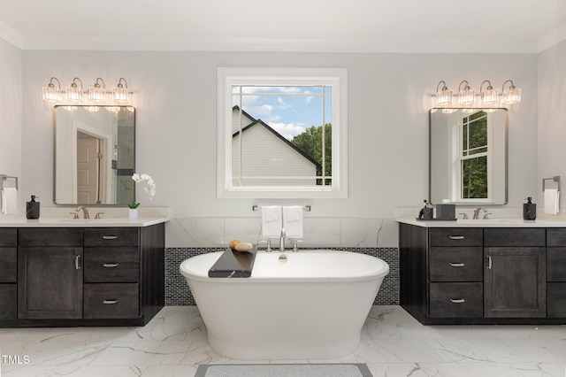 bathroom with a washtub, vanity, tile walls, and ornamental molding