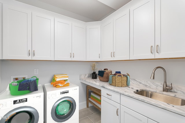 clothes washing area featuring tile patterned flooring, independent washer and dryer, cabinets, and sink