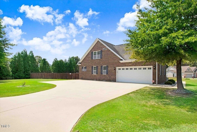 view of front of property featuring a front yard and a garage