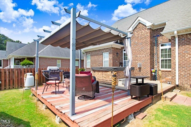 deck featuring a lawn, a pergola, and a hot tub