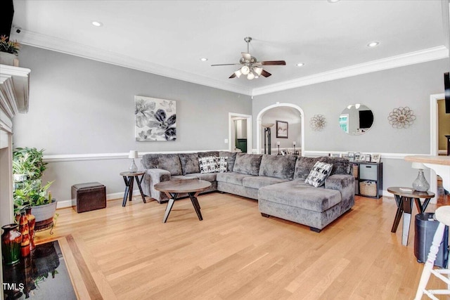 living room with ceiling fan, light hardwood / wood-style floors, and ornamental molding