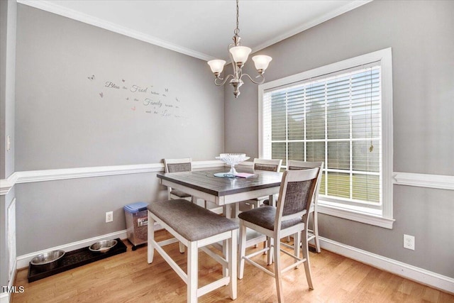 dining area featuring a healthy amount of sunlight, light wood-type flooring, and ornamental molding