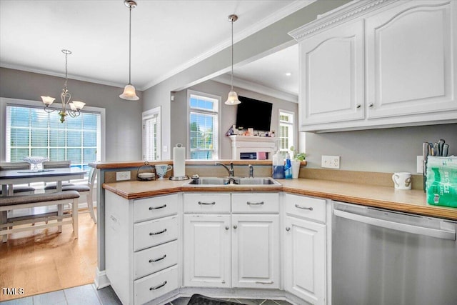 kitchen with sink, light hardwood / wood-style flooring, stainless steel dishwasher, pendant lighting, and white cabinets