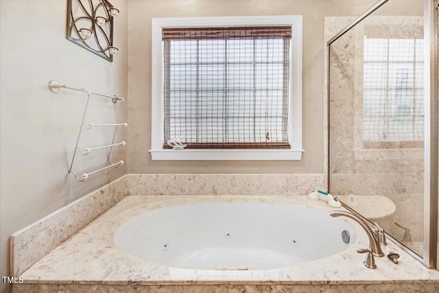 bathroom with a relaxing tiled tub