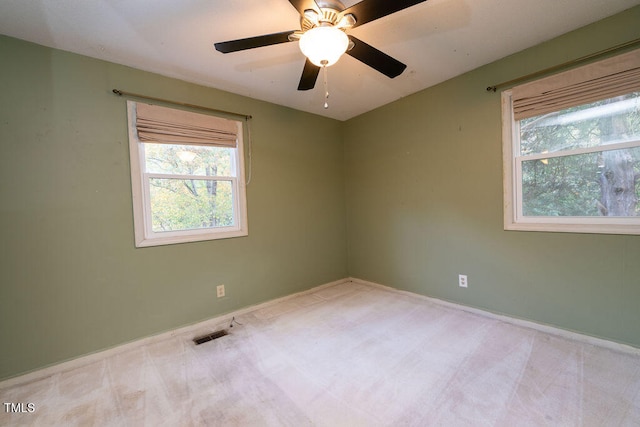 empty room with ceiling fan and light colored carpet