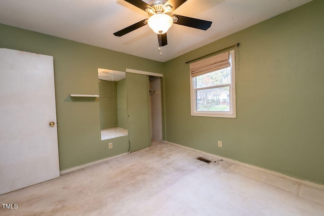 unfurnished bedroom with ceiling fan, a closet, and light carpet