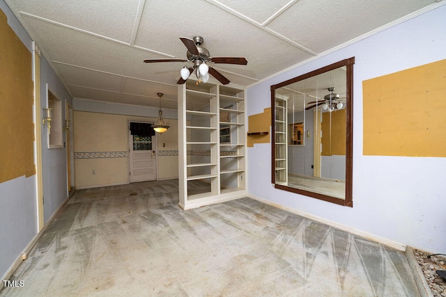 spare room featuring carpet flooring, ceiling fan, and a textured ceiling