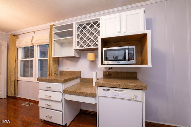 kitchen featuring white cabinets, dishwasher, ornamental molding, and dark wood-type flooring