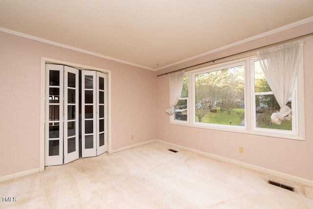 unfurnished room featuring crown molding and light carpet