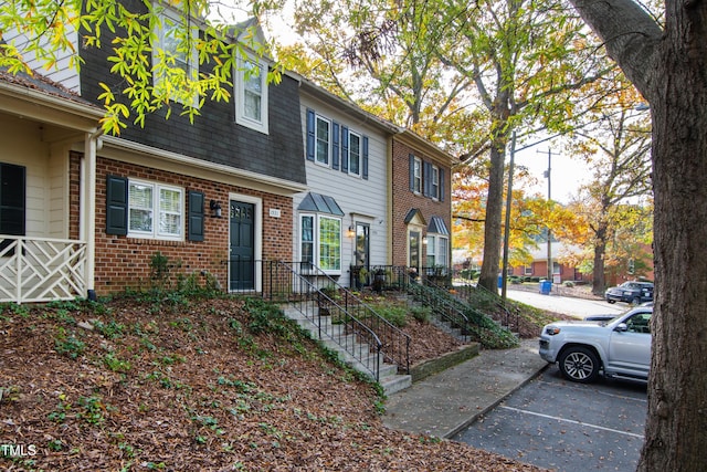 1321 Dylan Heath Ct, Raleigh, NC 27608 - view of property featuring brick siding and uncovered parking