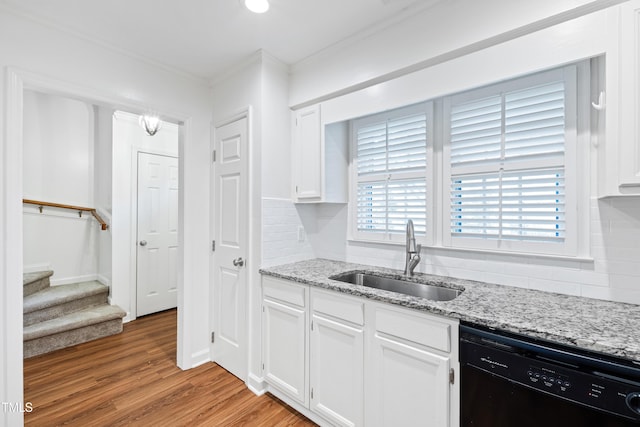 1321 Dylan Heath Ct, Raleigh, NC 27608 - kitchen featuring black dishwasher, backsplash, ornamental molding, white cabinetry, and light wood-style floors