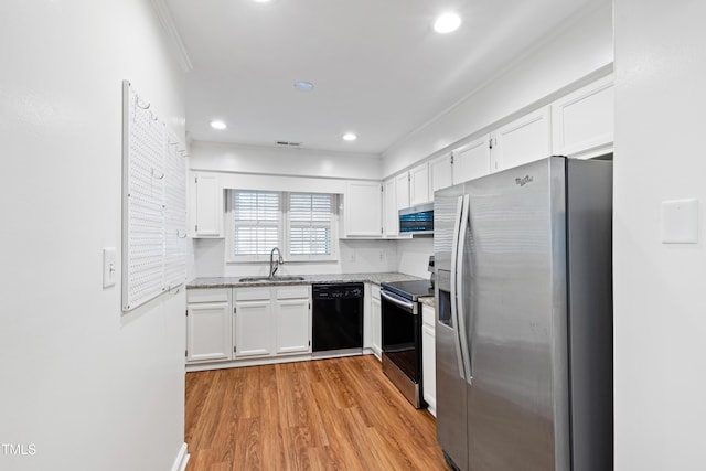 1321 Dylan Heath Ct, Raleigh, NC 27608 - kitchen with stainless steel appliances, white cabinetry, light stone countertops, light wood-type flooring, and crown molding
