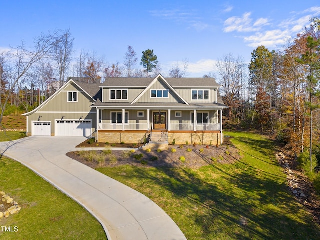 craftsman-style home with a front yard, a porch, and a garage