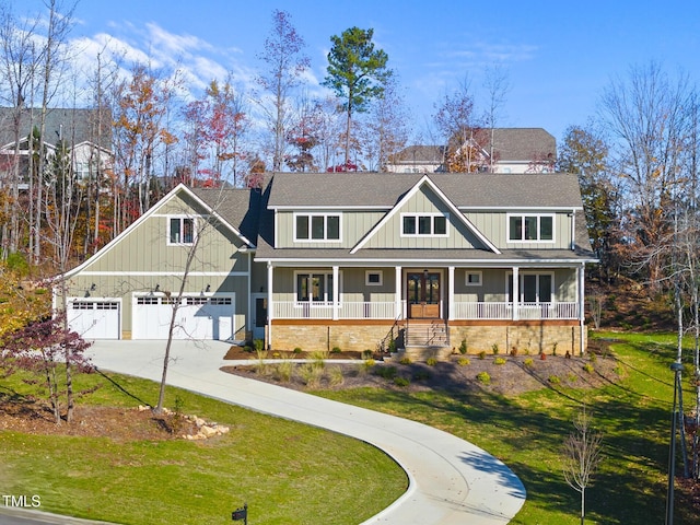 craftsman-style house with a garage, covered porch, and a front lawn