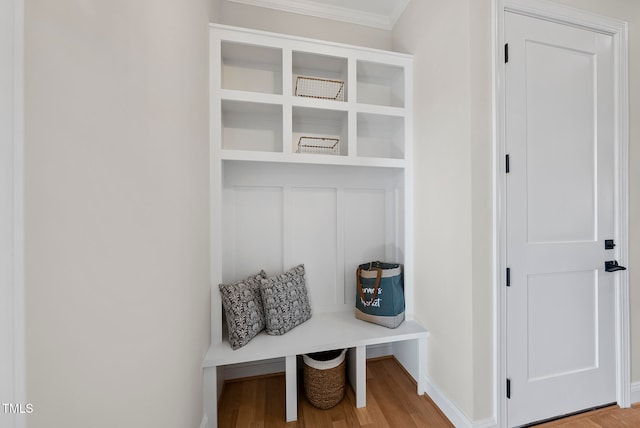 mudroom with light wood-type flooring and crown molding