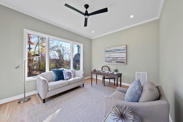 sitting room with hardwood / wood-style floors, ceiling fan, and ornamental molding