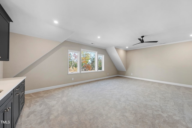 bonus room featuring light carpet and ceiling fan