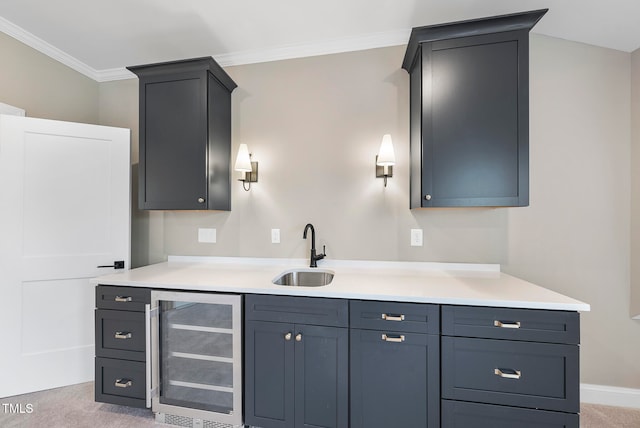 kitchen featuring wine cooler, sink, light colored carpet, and ornamental molding