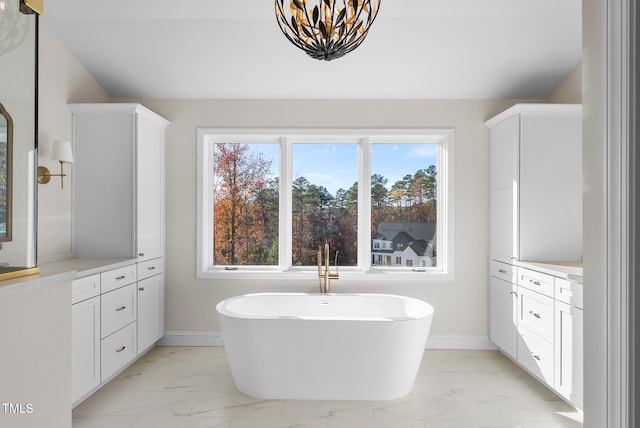 bathroom with a tub and vanity