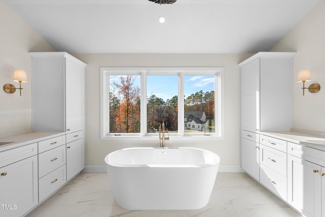 bathroom with vanity and a tub