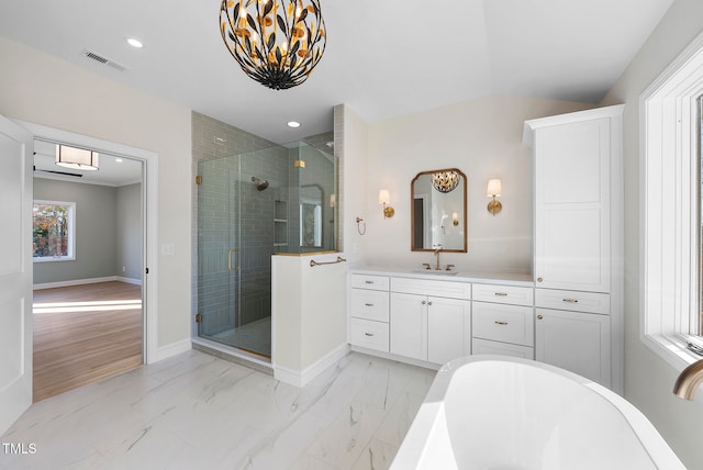 bathroom with hardwood / wood-style flooring, vanity, and walk in shower