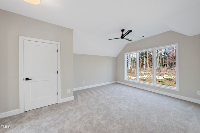 additional living space featuring ceiling fan, light carpet, and vaulted ceiling