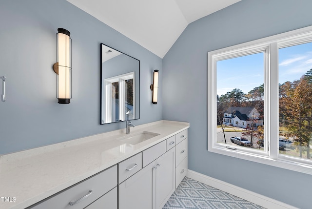 bathroom with vanity and vaulted ceiling