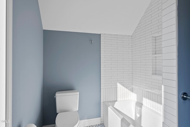 bathroom featuring a washtub, toilet, and lofted ceiling