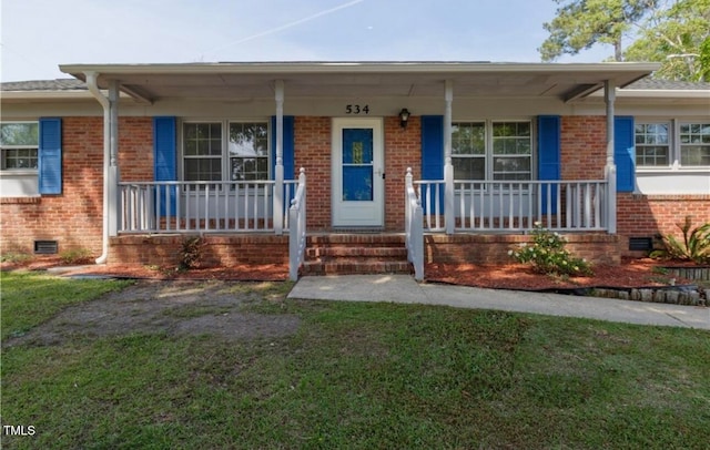 view of front of home with covered porch and a front yard