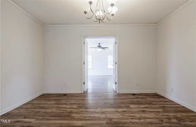 spare room with ceiling fan with notable chandelier, dark hardwood / wood-style flooring, and crown molding