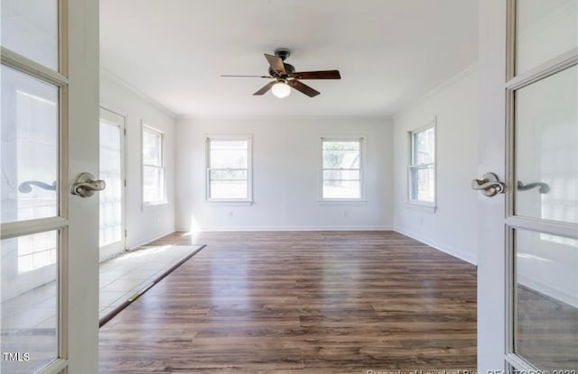 empty room featuring ornamental molding, french doors, ceiling fan, and dark wood-type flooring