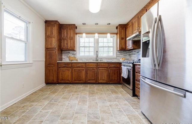 kitchen featuring pendant lighting, plenty of natural light, appliances with stainless steel finishes, and tasteful backsplash