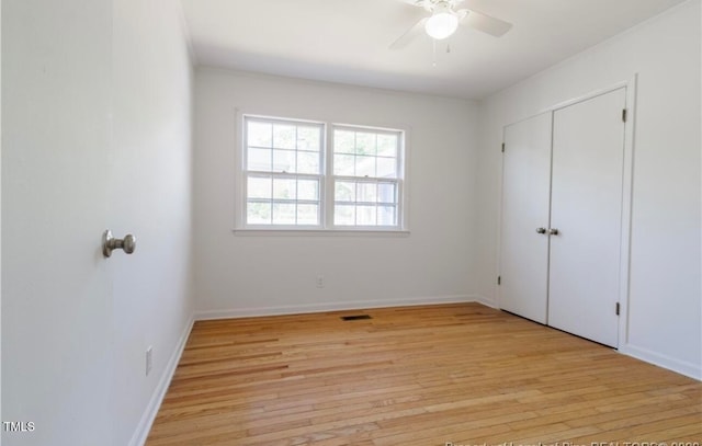 unfurnished bedroom with light wood-type flooring, a closet, and ceiling fan