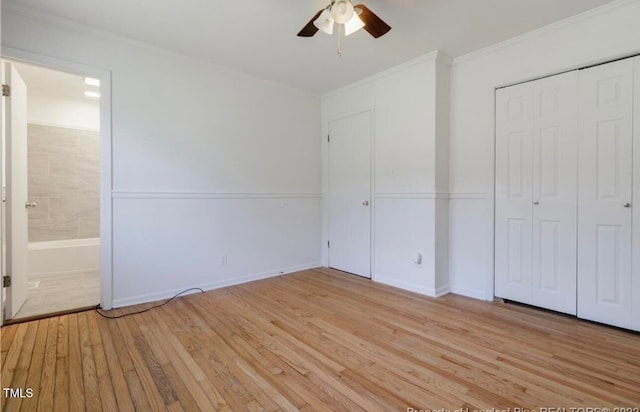 unfurnished bedroom featuring a closet, light hardwood / wood-style flooring, ceiling fan, and ornamental molding