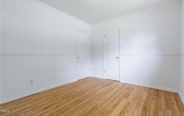 spare room with light hardwood / wood-style flooring and ornamental molding