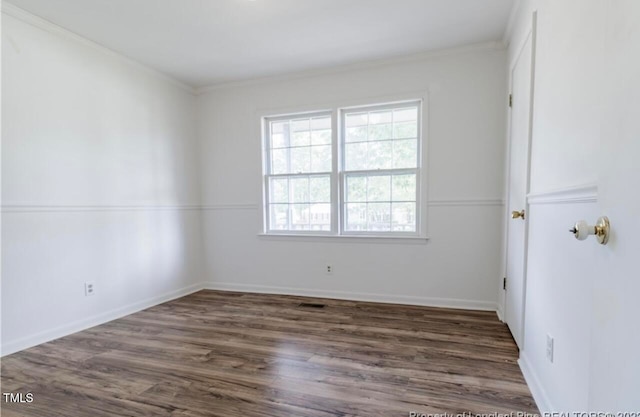 unfurnished room featuring crown molding and dark hardwood / wood-style floors