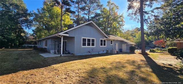 view of property exterior featuring a lawn and cooling unit