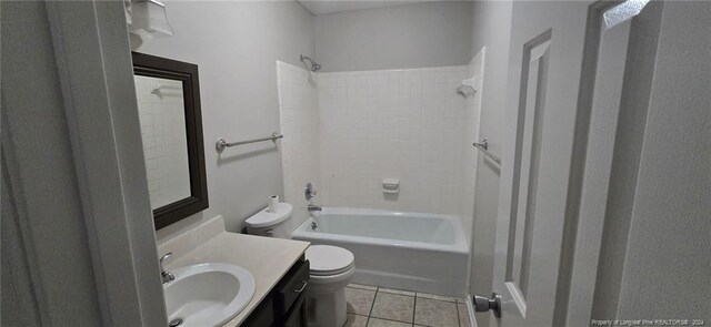 full bathroom featuring tile patterned flooring, vanity, toilet, and tiled shower / bath