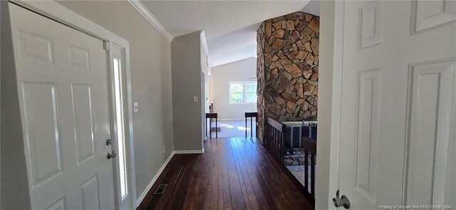 entryway featuring ornamental molding, dark hardwood / wood-style floors, and lofted ceiling